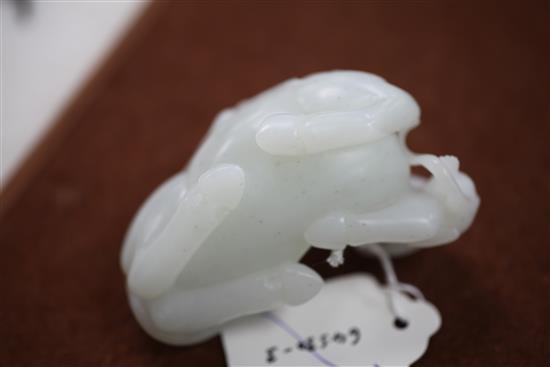 A Chinese white jade carving of two monkeys clambering on a recumbent horse, 20th century, 9cm, wood stand